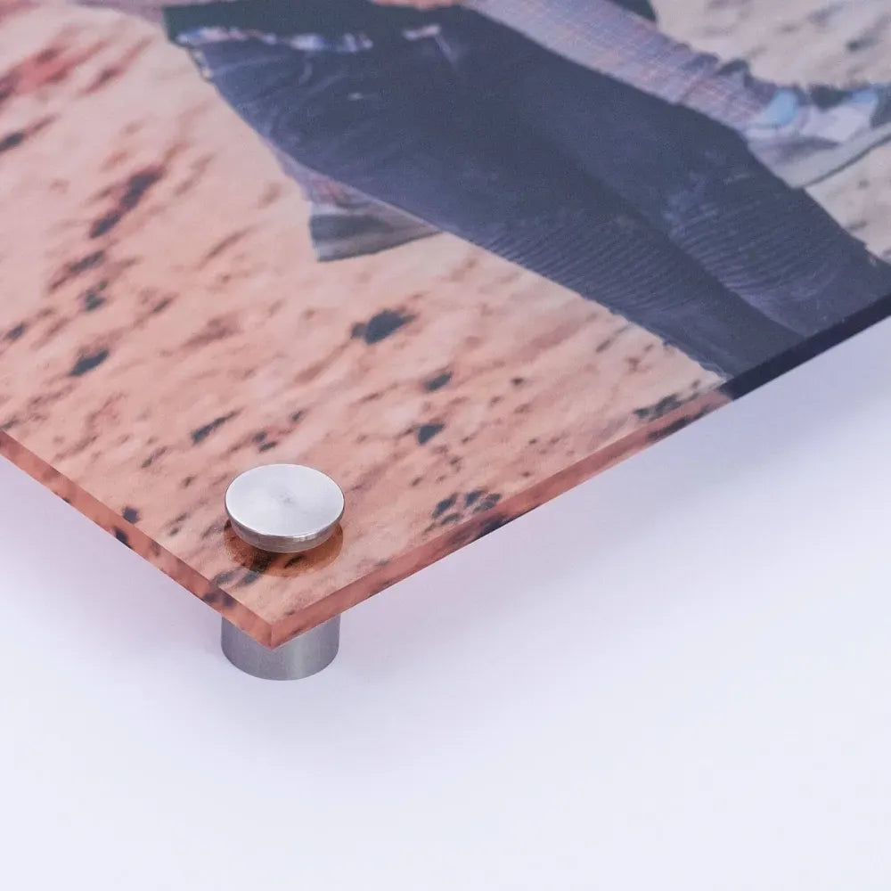 Close-up of an acrylic print corner showing polished edge and metal standoff