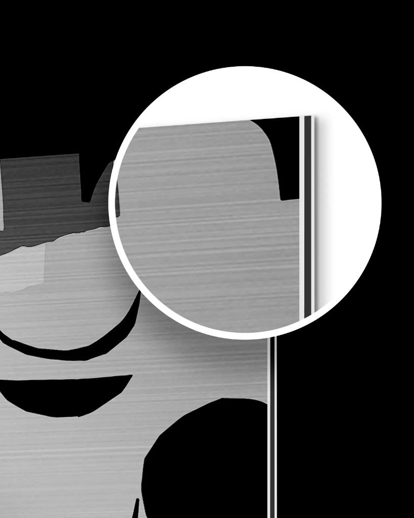 Magnified corner of a brushed aluminium print showing surface grain and sandwich edge