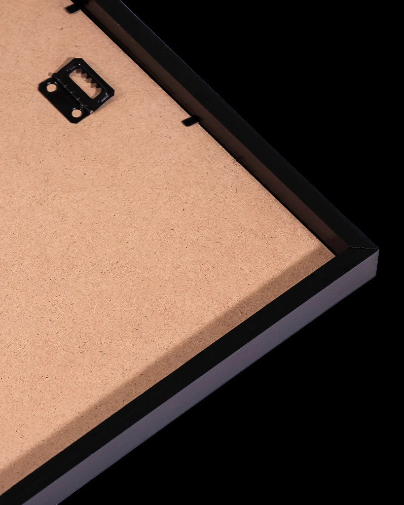 Back corner of a black wooden frame showing sawtooth hanger and backing board