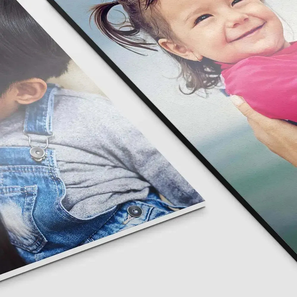Two foam prints close up, one of a boy in overalls and one of a smiling girl