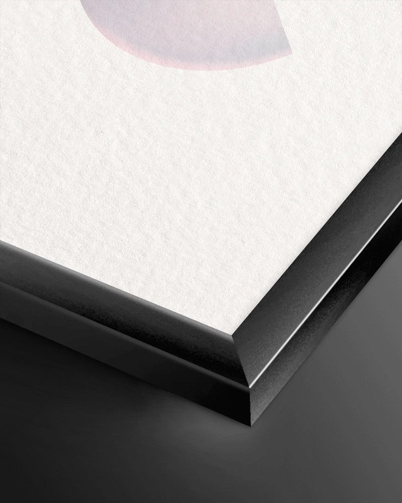 Close-up of a black metal frame corner showing the mitered join and paper inside